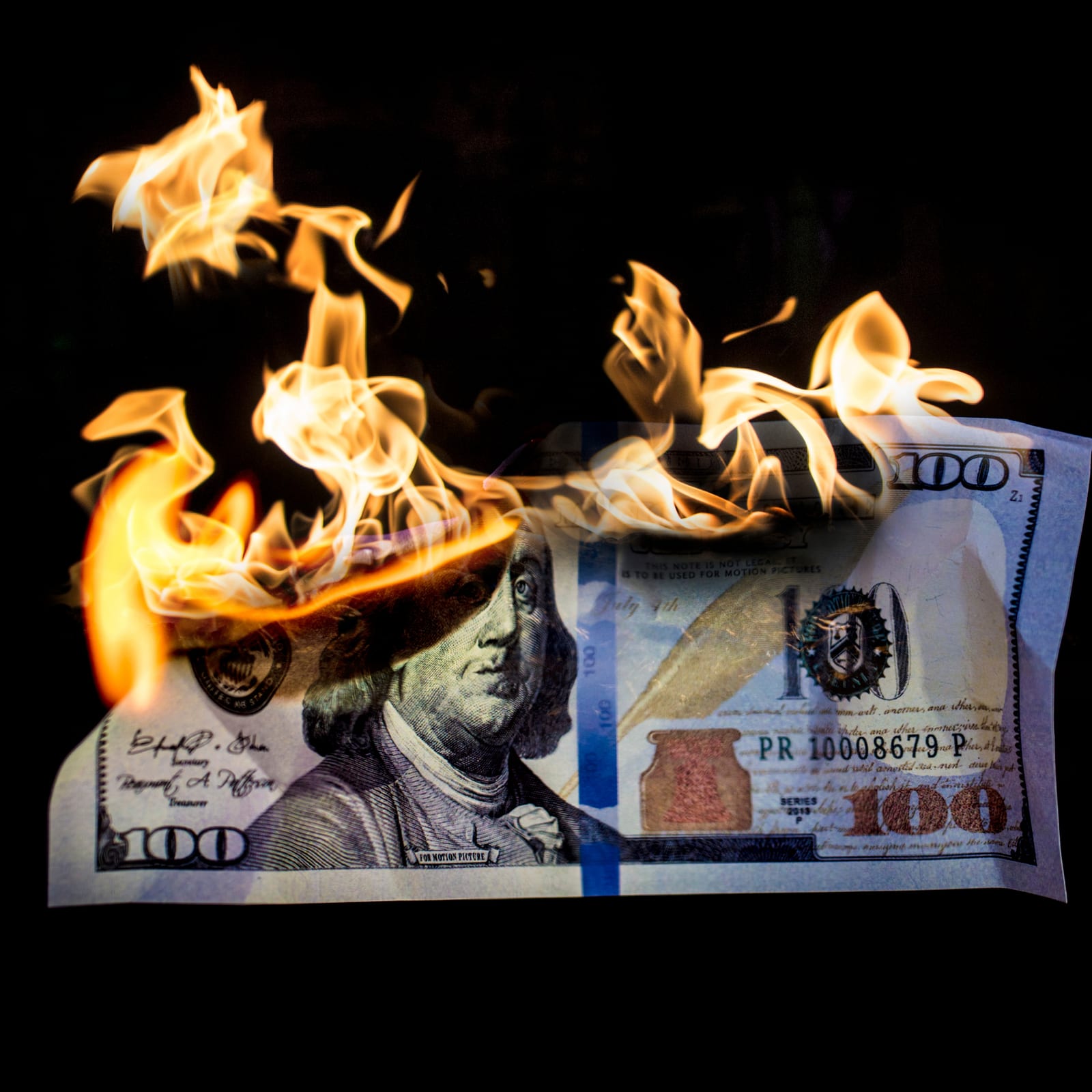 A burning $100 bill on a black background — visual metaphor for revenue leaking out of an unoptimized funnel
